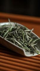 A Beautiful Display of Dried Green Tea Leaves Arranged on an Elegant and Stylish Dish