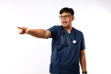 Fototapeta premium Young asian nurse man isolated on white background pointing away