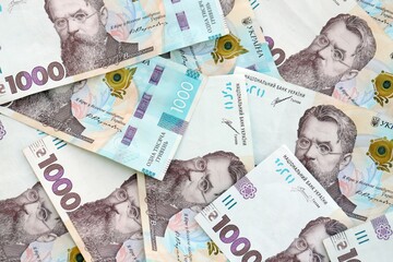 Big amount of ukrainian new one hundred hryvnia money bills with modern design. Financial concept, business