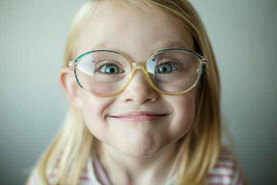 Portrait of a Girl wearing glasses being goofy and pulling a funny face