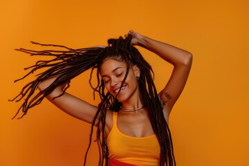 Young woman joyfully dancing and playing with hair.