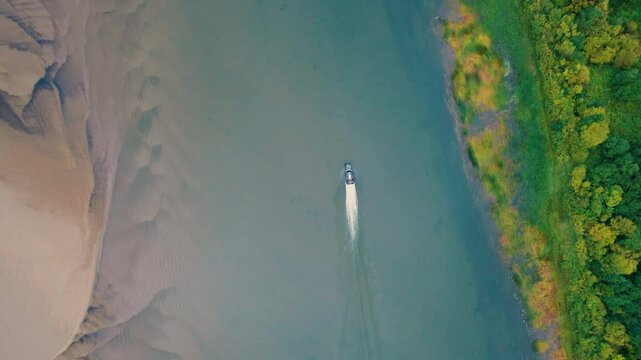 The airboat is traveling at high speed along the river. Universal water transport for overcoming water obstacles and shallow waters. A flat-bottomed vessel.