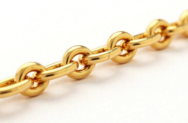 Fototapeta premium This golden metal chain showcases interconnected links, reflecting light on a smooth white surface