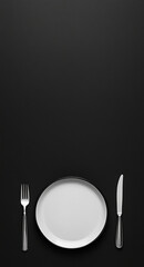 Elegant dining setup featuring a white plate and cutlery on a black table setting ready for a meal
