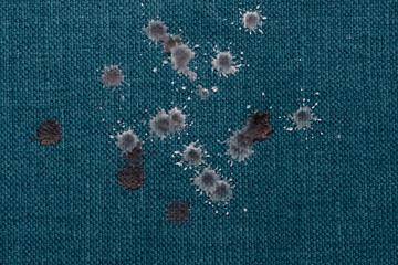 Close up drops of wax on turquoise clothes and upholstery, fun and games until the end of the...
