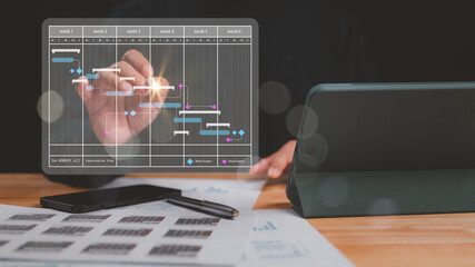 Focused individual analyzes Gantt chart displaying project timelines, task progress over six weeks visual tool aids in effective project management and time allocation