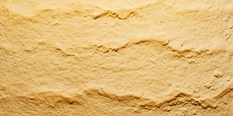 Fototapeta premium Close up of a textured yellow wall featuring a wavy pattern, ideal for backgrounds and design projects