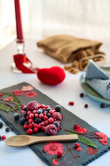 Close up of red fruits on a slate board. Concept of love and Valentine's Day