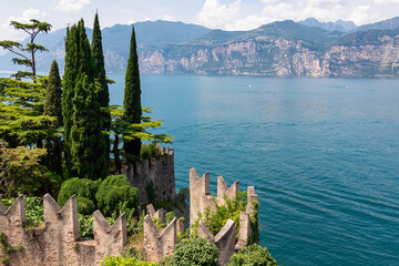 Cypress trees on Scaliger Castle along coastline of lakeside town Malcesine, Veneto, Northern...