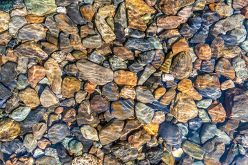 Pebbles under water background. Magnificent Seton Lake in Canada.