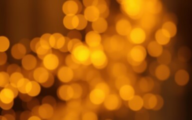 Soft golden lights create a warm and inviting atmosphere during a festive evening celebration at a cozy venue