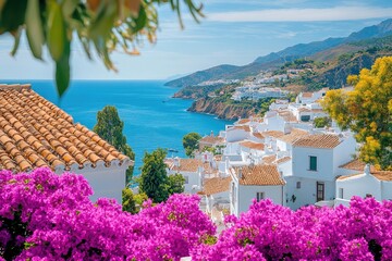 Bougainvillea blooming overlooking white houses and turquoise mediterranean sea in nerja, spain