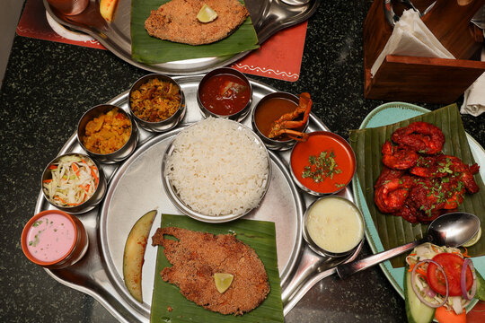 Goa Goan Fish Thali rice served with rawa fried seer fish, Sol Kadi Solkadhi Kokum curry Top View. Indian Fish Platter thali Popular sea food Non vegetarian meal Mumbai Konkan Maharashtra prawns 65