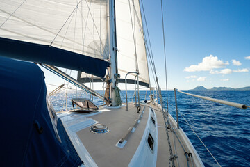 Beautiful charter sailing yacht sailing in the Caribbean with full sails up on a beautiful sunny day