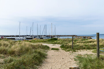 Sea pier with boats and yachts at sunset. Bornholm, Denmark