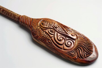 A beautifully carved wooden paddle featuring intricate patterns, showcasing cultural artistry and craftsmanship.