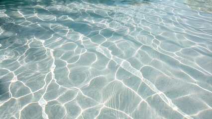 Peaceful water surface with gentle ripples and sunlight patterns