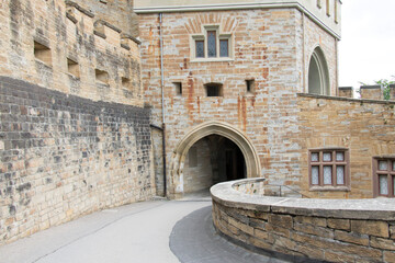Stone archway entrance to an ancient stone castle.