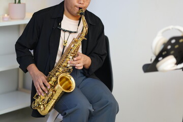 Fototapeta premium Working Asians are learning international musical skills at home