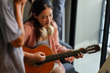 Fototapeta premium Working Asians are learning international musical skills at home