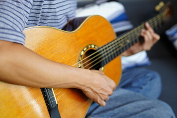 Fototapeta premium Working Asians are learning international musical skills at home