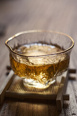 An Elegant Glass Filled with Amber Liquid Resting on a Beautiful Wooden Table Surface