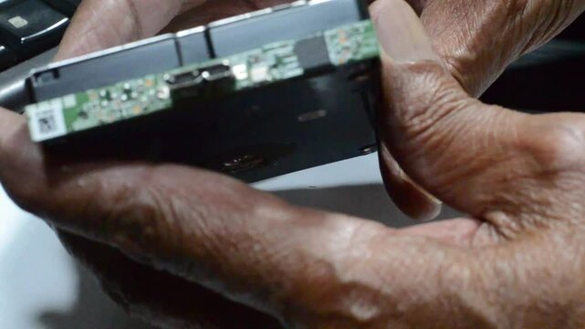 Hand-split opening of the external mini hard drive casing. close up