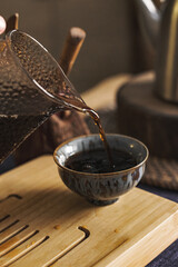 An Elegant Tea Pouring Gracefully into Fine Ceramics for a Unique Experience and Aroma