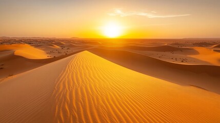 Vibrant sunset over vast, undulating sand dunes in a desert landscape.