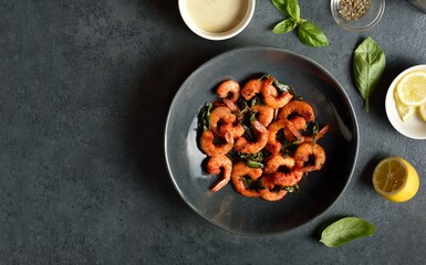 Roasted shrimp with basil leaves in bowl