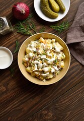 Warm potato salad with egg, pickle, red onion with mayonnaise an