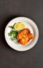 Schnitzel with lemon and leaves of parsley