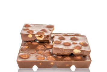One bar of dark chocolate with hazelnuts, close-up, isolated on a white background.