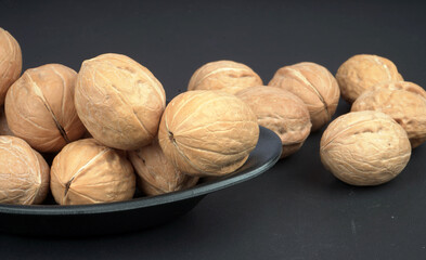 Fresh Quality walnut in black plate and background