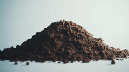A mound of dark soil, showcasing its texture and richness, possibly for gardening or agriculture.
