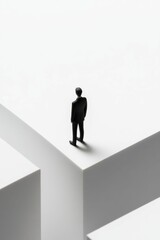 Miniature figure stands precipice, white geometric setting.