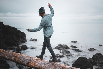 A Man Balancing On Log