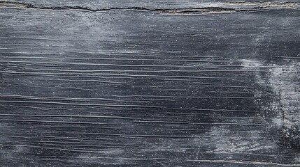 Fototapeta premium A black and white photo of a wooden surface with water droplets on it