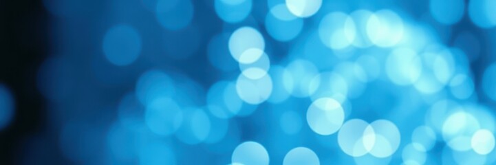 Bright blue bokeh lights create a magical atmosphere during a night event by the water in a bustling city