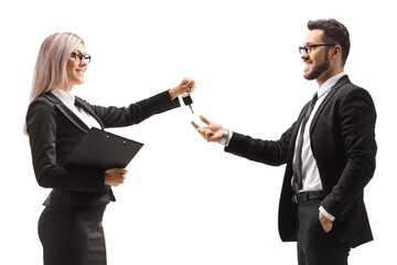 Businesswoman giving car keys to a businessman