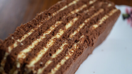 Layered chocolate cake on a plate close up