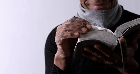 man praying to god with hands together worshiping God Caribbean man praying with people stock image stock photo