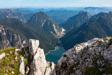 On top of Cima Del Lago with aerial view of alpine lake Lago Del Predil in Val Canale surrounded by...