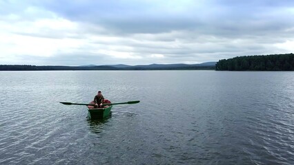 Enjoy a Serene Rowing Experience on a Calm and Picturesque Lake Surrounded by Nature. Stock Clip