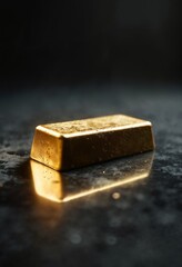 Shiny gold bullion bar on reflective surface with dramatic lighting