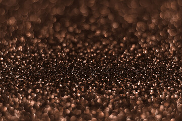Brown, mocha mousse sparkling glitter bokeh background, abstract defocused texture. Holiday lights. Demonstrating color, trend 2025 year