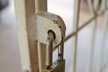 A pad lock attached to a secure gate 