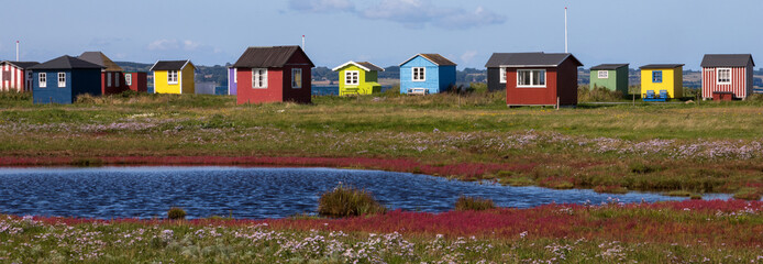 salt marsh with colorful beach huts at Vesterstrand, &AElig;r&oslash;sk&oslash;bing, &AElig;r&oslash;, Denmark