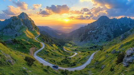 Panoramic sunset view of winding mountain road.