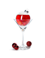 Presentation of Christmas cocktail in bauble and glass on white background